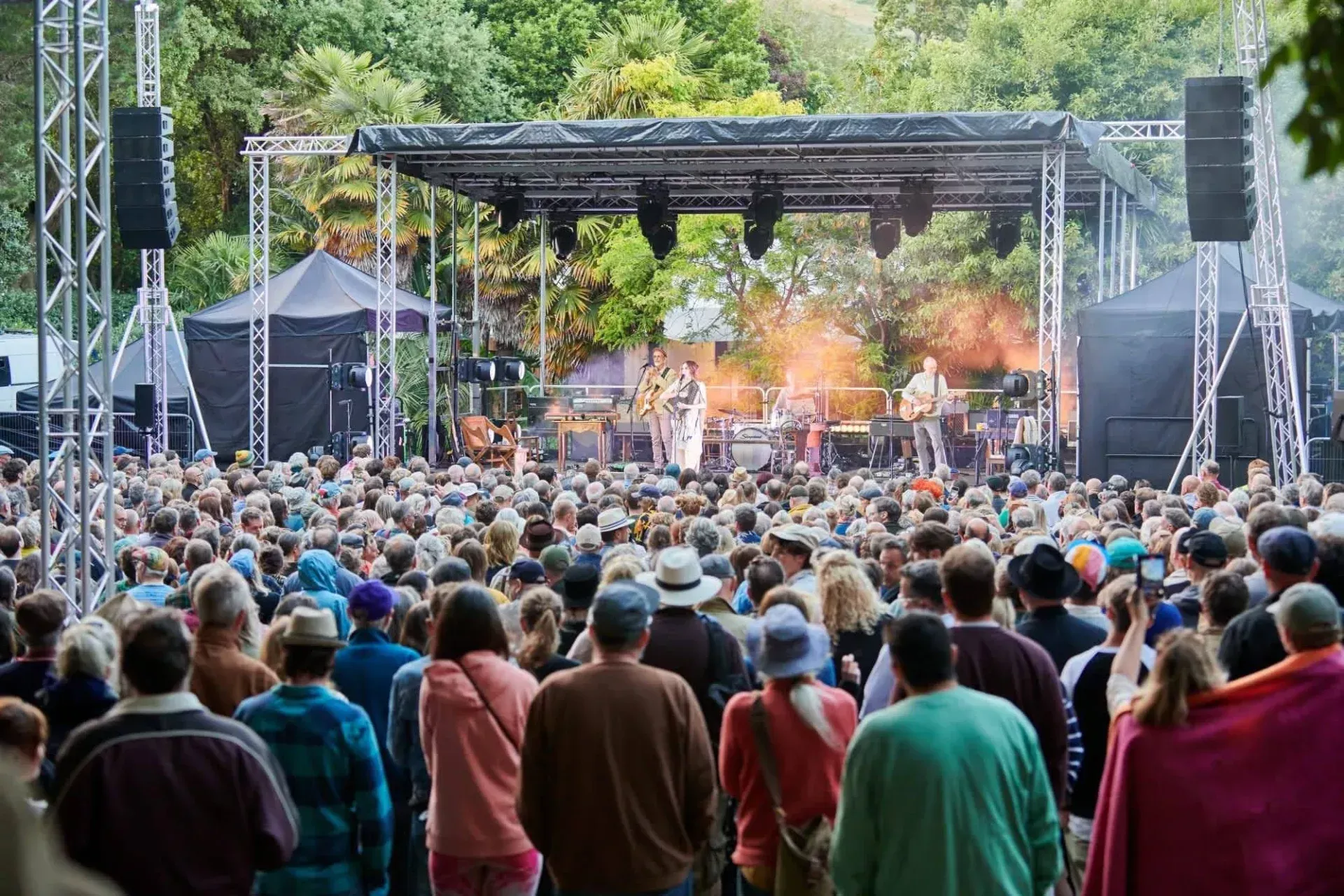 Crowd in front of an EEH trailer stage at an outdoor music event